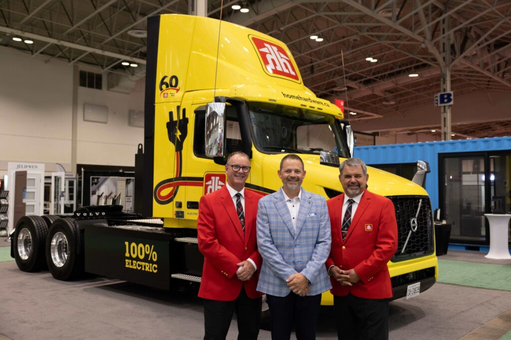 Group shot in front of electric truck