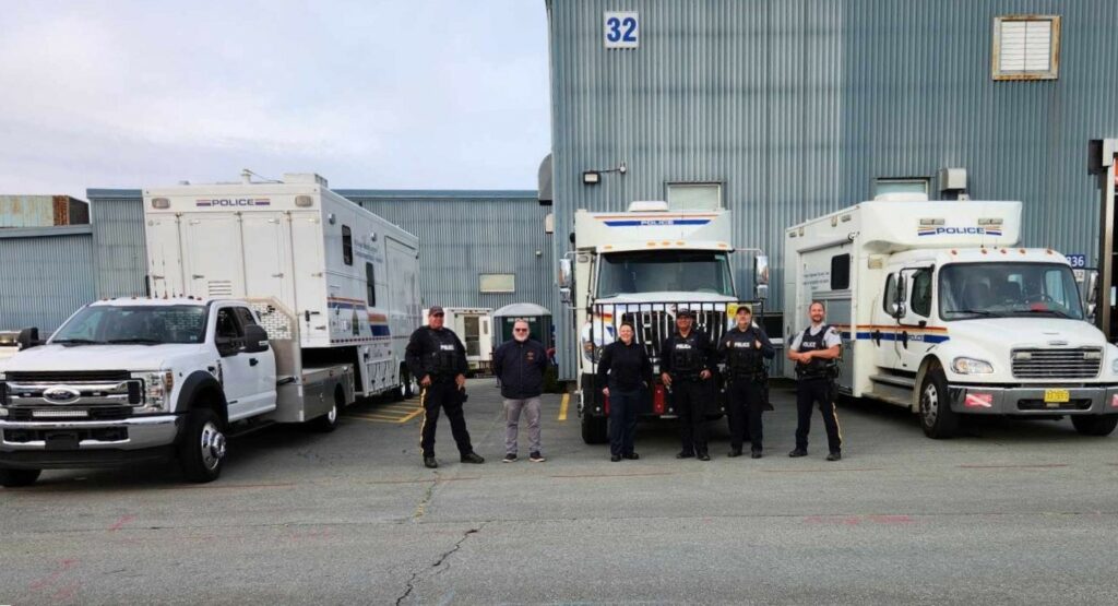 Police at the truck convoy in front of their trucks