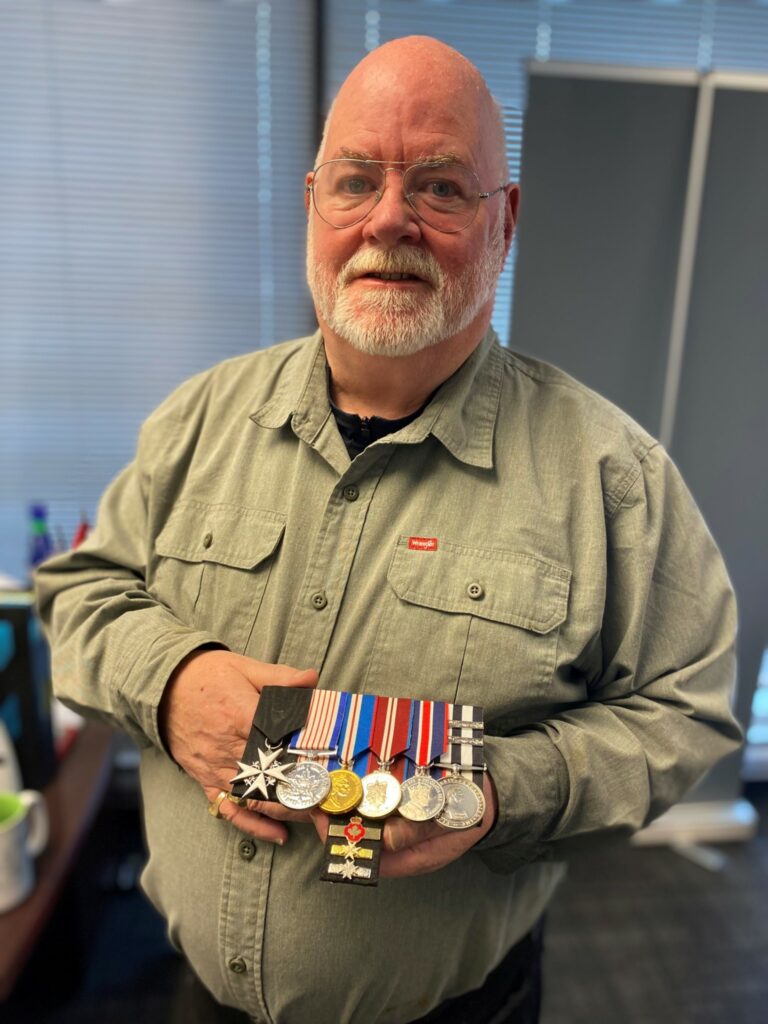 (Photo: Leo Barros) Picture of Brian Patterson displaying his medals