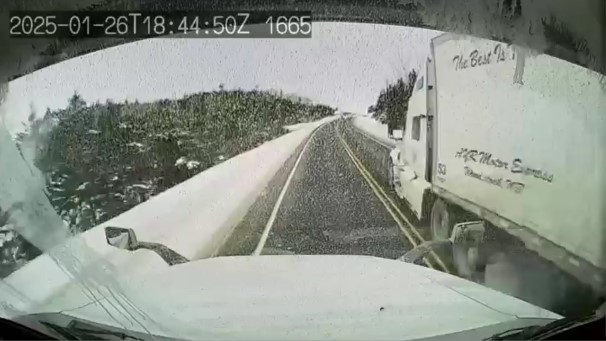 A truck passing another truck on the highway