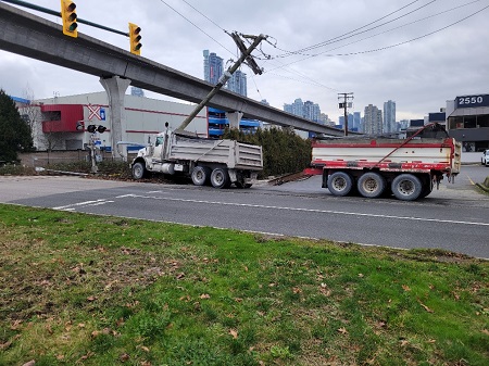 Picture of a dump truck that crashed into utility poles