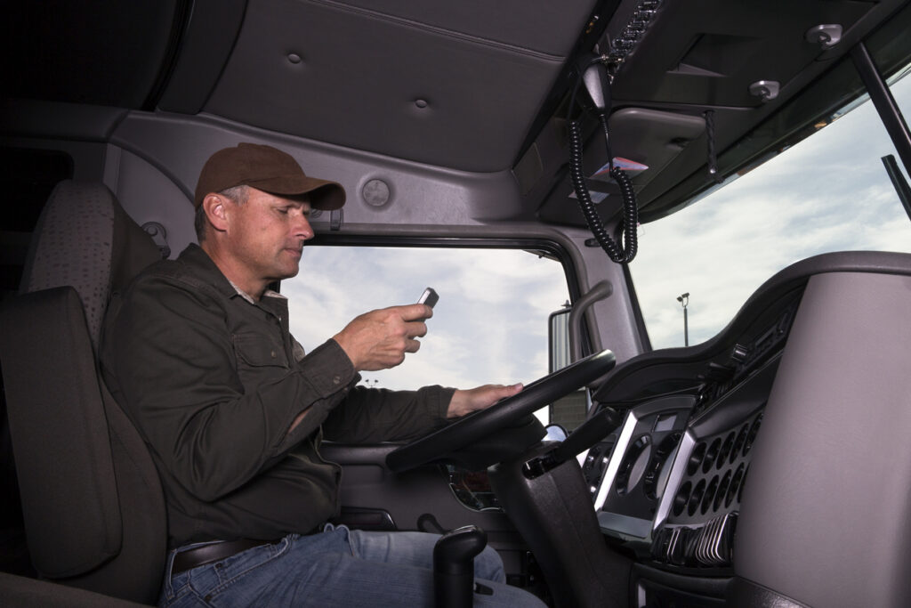 (Photo: iStock) A truck driver texts while behind the wheel