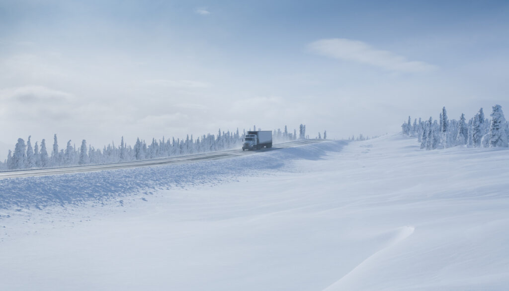 Big Rig Semi-Truck driving on an Arctic Winter Highway in Alaska